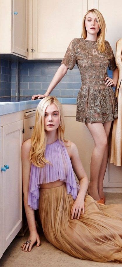 Two Women Standing In A Kitchen Next To Each Other And One Is Wearing A Dress
