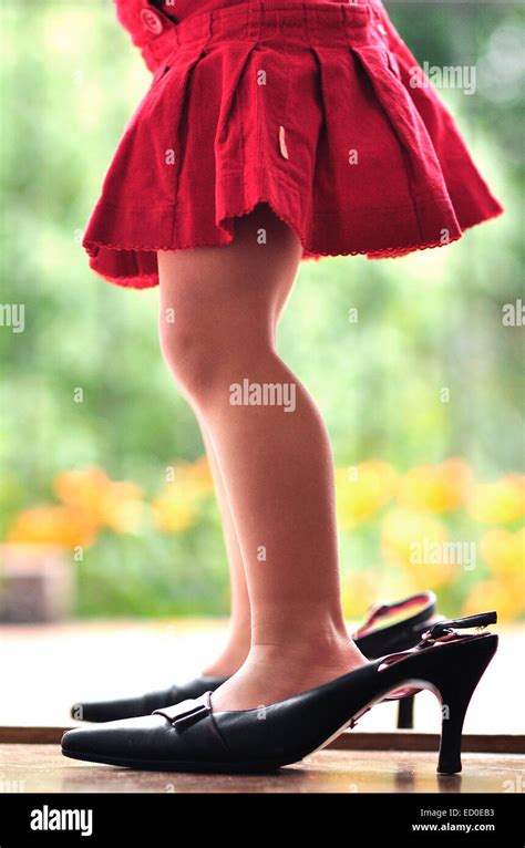 Close Up Of A Girl Trying On Her Mothers High Heel Shoes Stock Photo