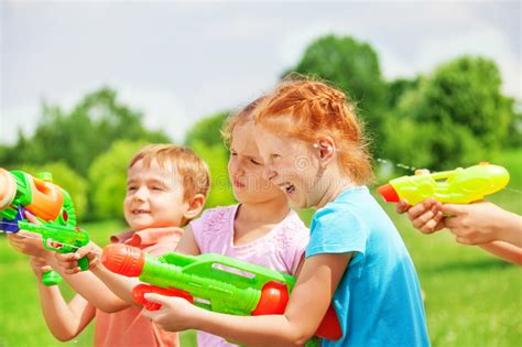 Funny Kids Playing With Water Guns Stock Photo Image Of