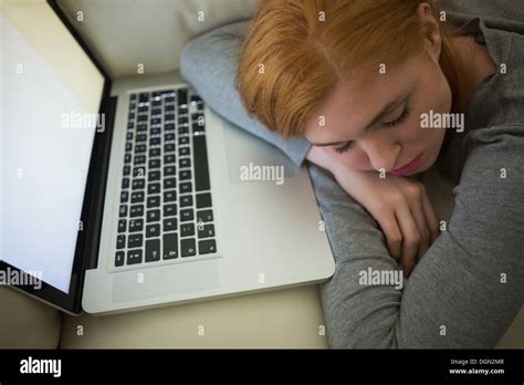 Redhead Sleeping On The Couch With Her Laptop Stock Photo Alamy