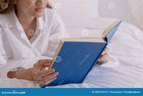 Young Woman Reading Book On Bed At Home Stock Photo Image Of Female