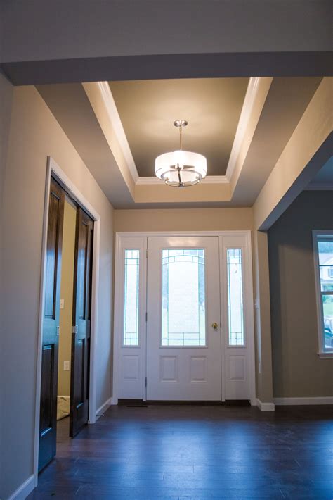 Front Entry Way And Foyer With Modern Light Fixture And Tray Ceilings