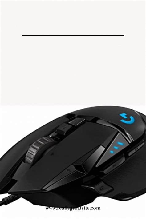 A Computer Mouse Sitting On Top Of A White Table Next To A Black And