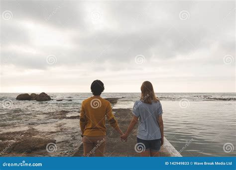 Caucasian Couple Standing On Rock Near Beach Stock Image Image Of
