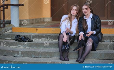 Tired Schoolgirls Sit Barefoot On The Steps Of The School Stock Footage Video Of University