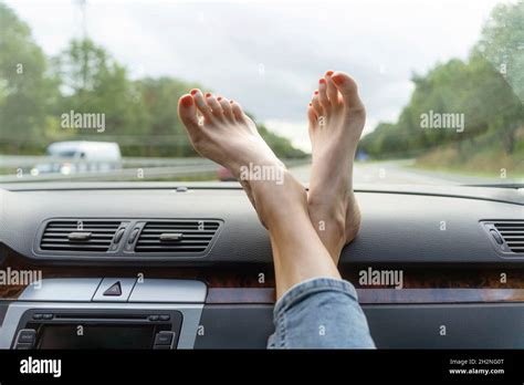 Mature Woman With Feet Up On Car Dashboard Stock Photo Alamy