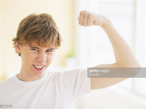 Teenage Boy Flexing Muscles High Res Stock Photo Getty Images