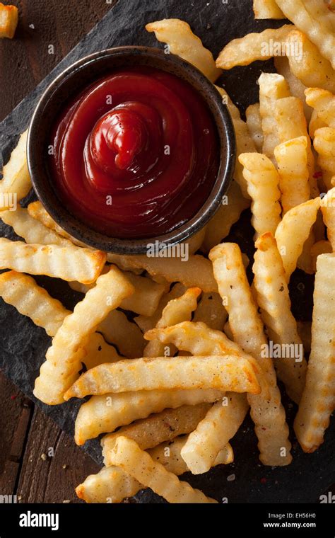 Unhealthy Baked Crinkle French Fries With Ketchup Stock Photo Alamy
