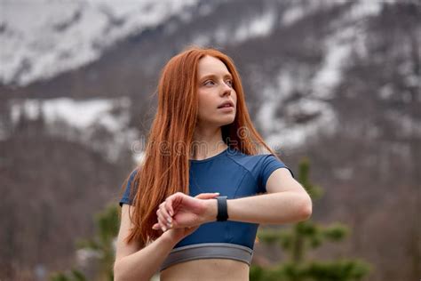 Fit Young Redhead Woman Looking At Side Checking Time After Running During Workout Stock Image