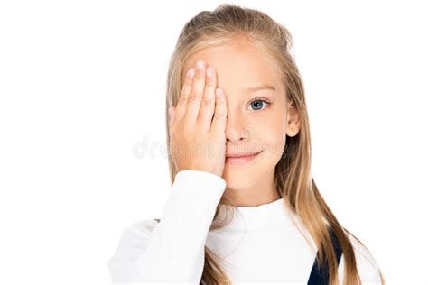 Adorable Cheerful Schoolgirl Covering Eye With Hand While Looking At