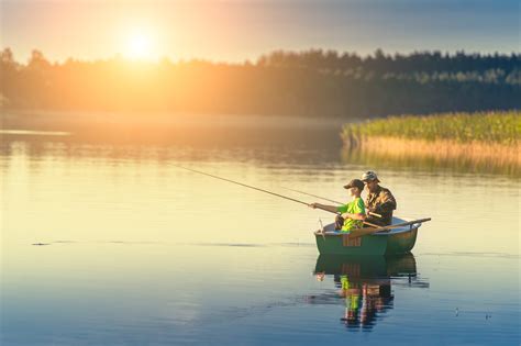 Father And Son Catch Fish From A Boat At Sunset My Westshore