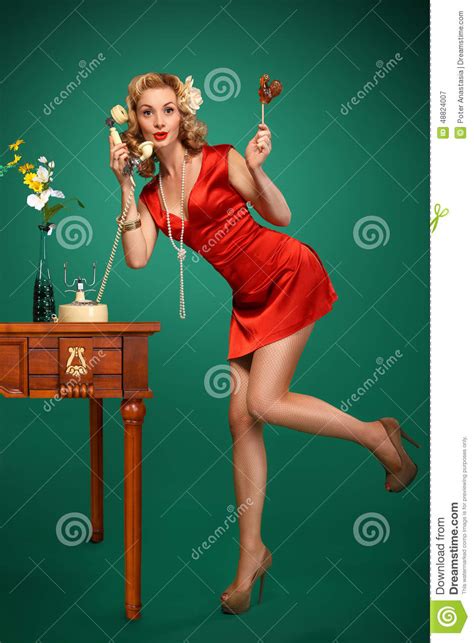 Pin Up Girl Talking On Retro Phone And Holding A Lollipop Stock Image