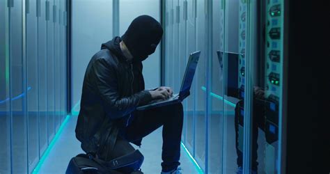 Hacker In Black Mask Using Computer Breaking Stock Footage Sbv