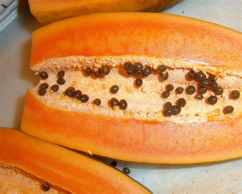 The Inside Of A Papaya With Seeds On It