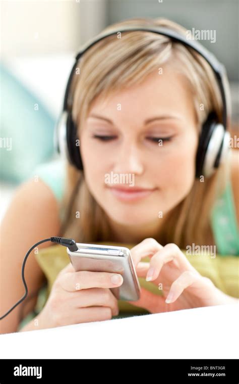 Pretty Young Woman Listening Music Lying On A Sofa Stock Photo Alamy