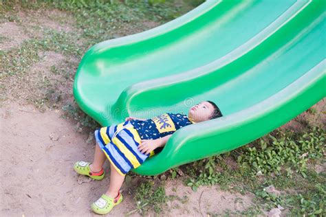 Little Asian Kid Playing Slide At The Playground Stock Image Image