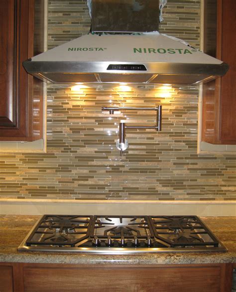 A pot filler is one of those kitchen luxuries. New Mosaic Tile Backsplash with Pot Filler Faucet and ...