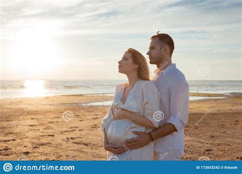 Romantic Walk On The Beach Waiting For A Baby Happy Young Couple
