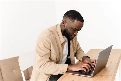 Premium Photo Focused African American Man Working On Laptop From Home Black Freelancer