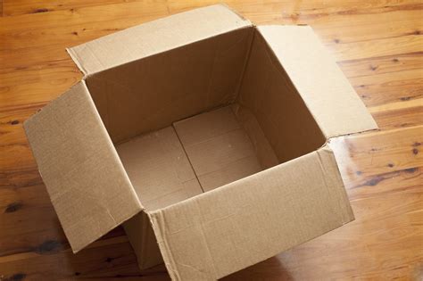 Empty Cardboard Box With Open Flaps On Wood Floor Free Backgrounds