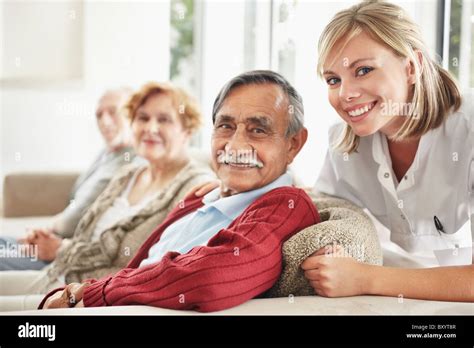 Nurse With Patients In Clinic Stock Photo Alamy