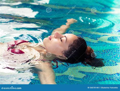 Young Brunette Woman Swimming In The Swimming Pool At The Hotel Stock