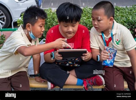 Chinese Primary School Students Play Video Games With A Pad After