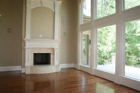 Two story fireplace wall ideas. hardwood floors + high ceilings + lots of windows ...