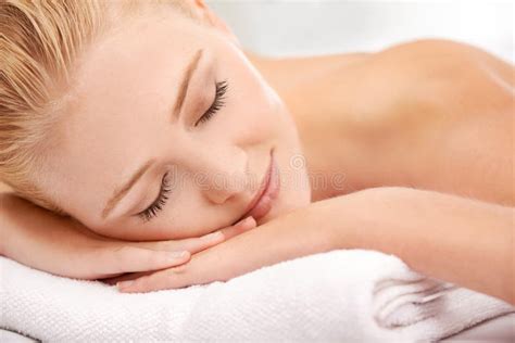 Smile Of Satisfaction Closeup Shot Of A Woman Lying On A Massage Table At A Spa Stock Image