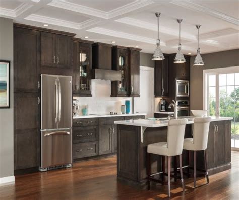 A custom swooped kitchen hood is one of the many inspiring details this kitchen features. Dark Gray Kitchen Cabinets - Aristokraft in 2020 (With ...
