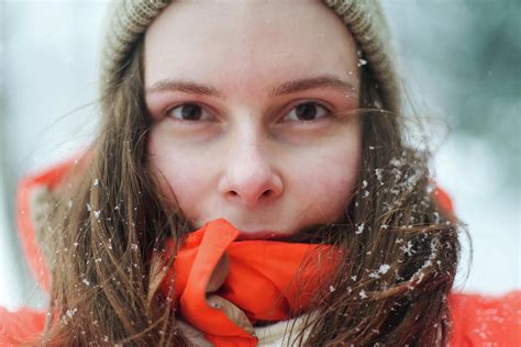Close Up Portrait Of Woman In Orange Jacket During Winter In The