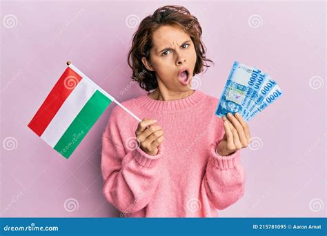 Young Brunette Woman Holding Hungary Flag And Forints Banknotes In