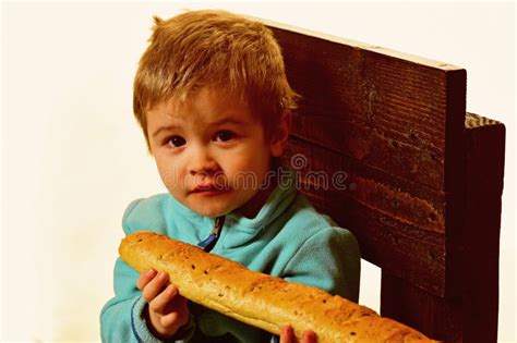 Little Boy Eat Bread At American Flag At Knowledge Day Back To School