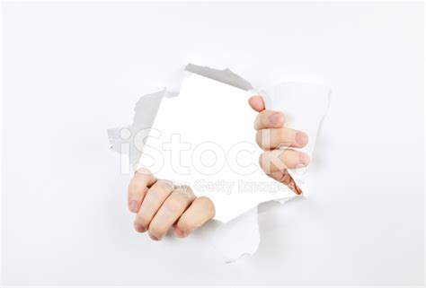 Hands Ripping Through Hole In Paper Stock Photos