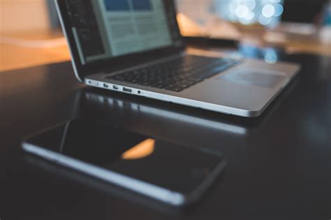 Laptop Computer And Iphone On Black Desk Royalty Free Stock Photo