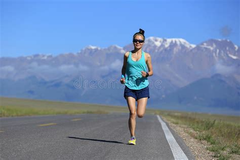 Lifestyle Young Fitness Woman Runner Running On Road Stock Photo