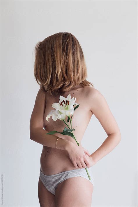 Topless Woman With Lily By Stocksy Contributor Lucas Ottone Stocksy