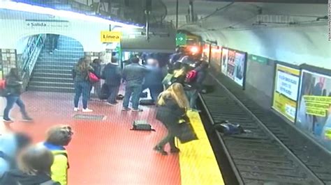 Moment Woman Falls Onto Subway Tracks And Is Pulled To Safety Cnn Video