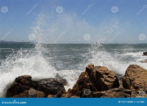 Big Storm Waves Hitting The Coastal Rocks Of The Sea Sunny Windy Day