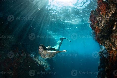 Mermaid Swimming Underwater In The Deep Blue Sea 20347214 Stock Photo