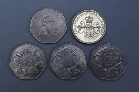 Four Collectable 50p Coins And A Collectable 2 Pound Coin