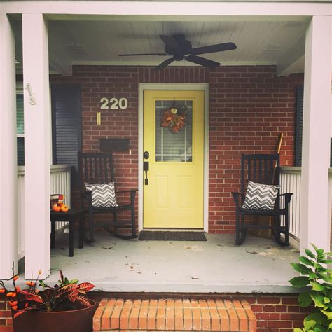 Although most homes today are painted either in magnolia or white, gray is by far the most preferred color as it goes with pretty much everything. #helloyellow! bright yellow front door with red brick ...