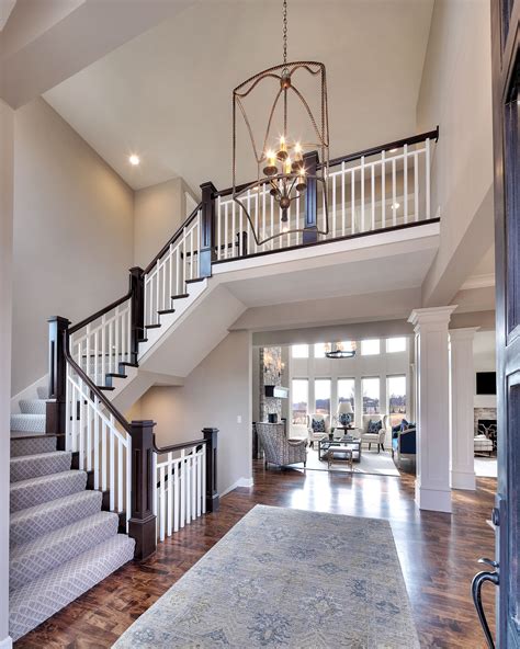 Entry Curved Staircase Open Floor Plan Overlook From