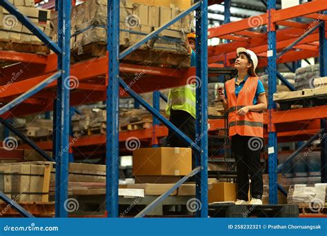 Warehouse Workers Wearing Safety Hardhat Working on Retail Warehouse