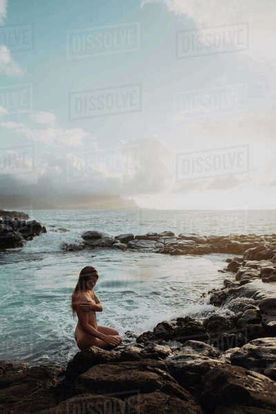 Naked Woman Sitting On Rocks By Sea Pool Princeville Hawaii Us Stock Photo Dissolve