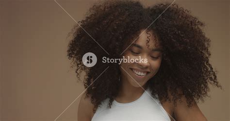 Mixed Race Black Woman Portrait With Big Afro Hair Curly Hair In Beige Background Natural