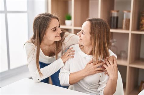 Two Women Mother And Daughter Hugging Each Other At Home Stock Image