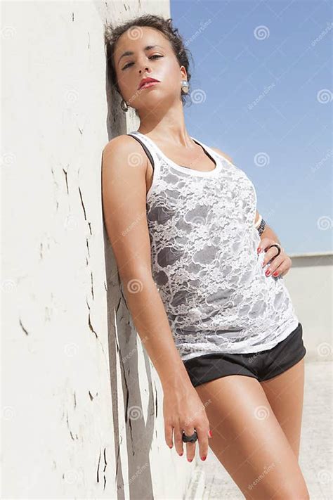 Sensual Brunette Tanned Girl Leaning On A Wall Hot Sun Stock Image