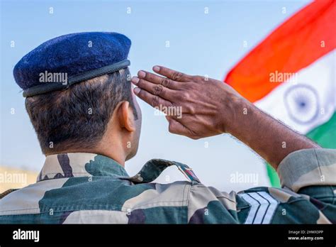 Back View Shot Of Proud Indian Army Soldier Saluting By Looking Indian