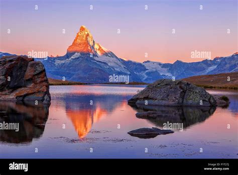 Pink Sky At Sunrise On The Matterhorn Reflected In Stellisee Stock